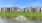 water fountains in large pond next to apartments