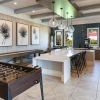 foosball and shuffleboard tables in game room